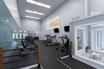 A gym with a variety of equipment and a sign that says 
